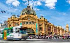 Pedestrians and cylers at the iconic Flinders Street Station in Melbourne, Victoria Australia